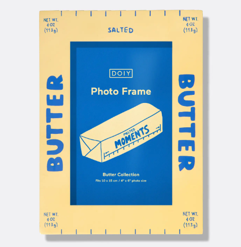 A bright yellow ceramic photo frame shaped like a stick of butter, featuring "BUTTER" text and "SALTED" graphics.