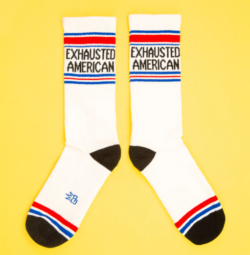 A pair of "Exhausted American" socks, highlighting the mid-calf length and ribbed texture.