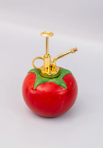 Keep your plants thriving in style! This whimsical Ban.do Tomato Plant Mister with its ceramic base and easy-to-use gold spray handle is a must-have for any plant enthusiast.