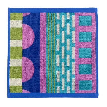 A square cotton face cloth patterned with a cheerful mix of polka dots, stripes, and colorful graphic blocks.