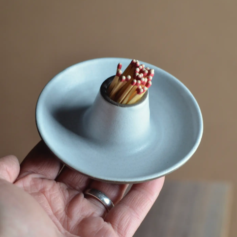 The Berliner match striker in matte white showcasing the unique wheel-thrown texture and artisanal glaze.