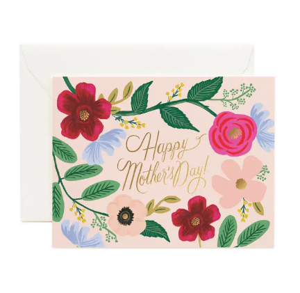 A horizontal light pink Mother's Day card featuring the words "Happy Mother's Day!" in gold foil surrounded by red, pink, and blue flowers.