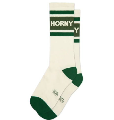 Flash a bit of cheeky humor with the Horny Gym Crew Socks by Gumball Poodle, featuring a classic cream-white and green ribbed design knit with bold block lettering.