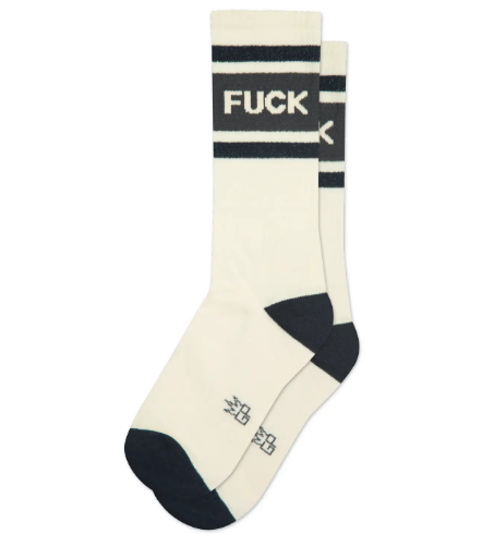 A pair of cream-colored crew socks with black stripes and the word FUCK knit into the top in bold white letters.