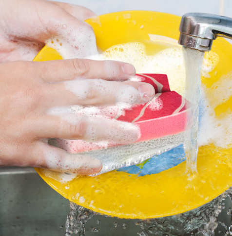 Make dishwashing fun and effortless with the Washabi Sponges Set of 3 by Fred & Friends, shown here actively scrubbing a soapy yellow plate under running water.
