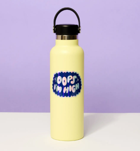 Personalize your favorite yellow water bottle with the holographic Oops I'm High sticker by And Here We Are, adding a playful and shimmering touch.