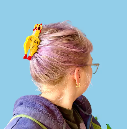 Model wearing the Rubber Chicken Hair Claw, highlighting the details of the chicken design and the rhinestones on the collar.