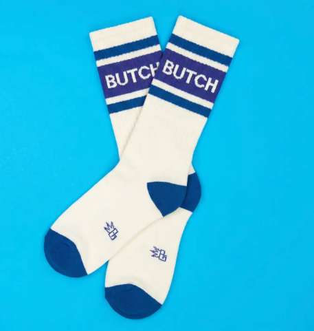 Coordinate your sneakers with American-made statement socks showcasing a wide ribbed calf, contrast blue heel and toe caps, and bold text graphics.