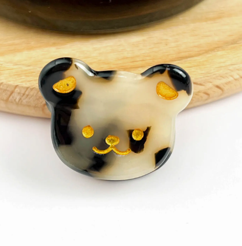 A leopard bear head-shaped mini hair clip, showcasing its adorable and fun design.