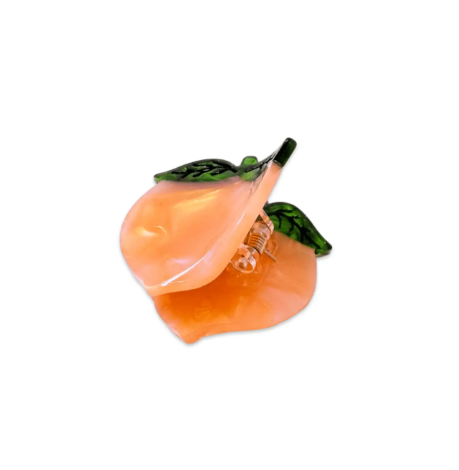 The Jenny Lemons Mini Peach Hair Claw, viewed from the side, highlights its compact size, secure grip, and the unique, hand-painted details for effortless styling.