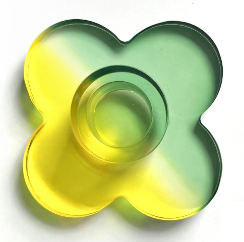 Close up of the Daisy durable acrylic candlestick holder featuring a stylish yellow, green dual-toned design.