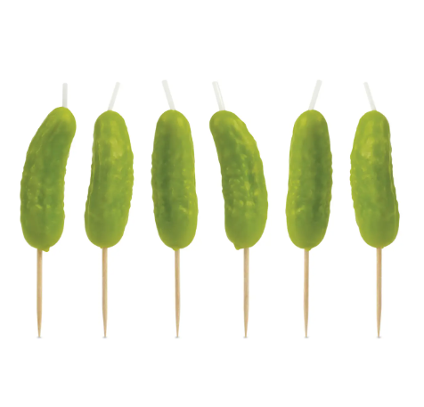 A lineup of the six quirky pickle-shaped birthday candles by Fred & Friends, each featuring a wooden pick for easy cake placement.