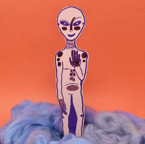 A stylish and otherworldly Pale Pink leather bookmark featuring a fun embossed alien design.