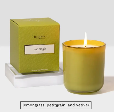 A vibrant, lime-green Little Torch candle labeled Lost Jungle, paired with its matching box and glowing wick, designed to capture the lush spirit of an untamed world.