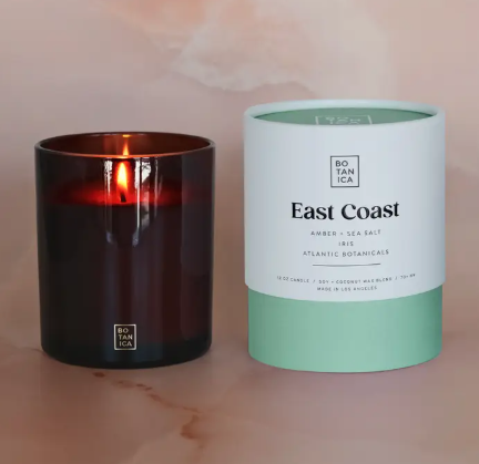 A large BOTANICA East Coast Signature Candle in a minimalist glass jar with a 100% cotton wick.