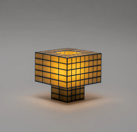Showcase the compact Tesser 5:3 Lamp by Ridezign in butter yellow, highlighting its cube-like proportions and grid structure.