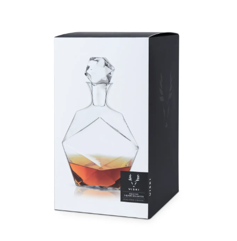 A 40 oz lead-free crystal decanter with a triangular base and unique faceted sides for showcasing liquor.