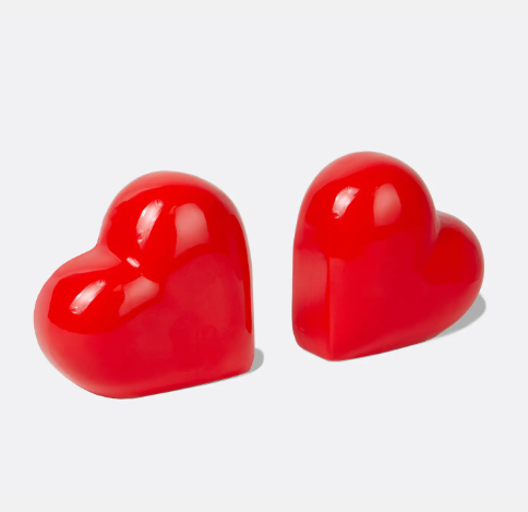A close-up of the two red heart bookends, emphasizing their glossy finish and beautiful, symbolic shape.