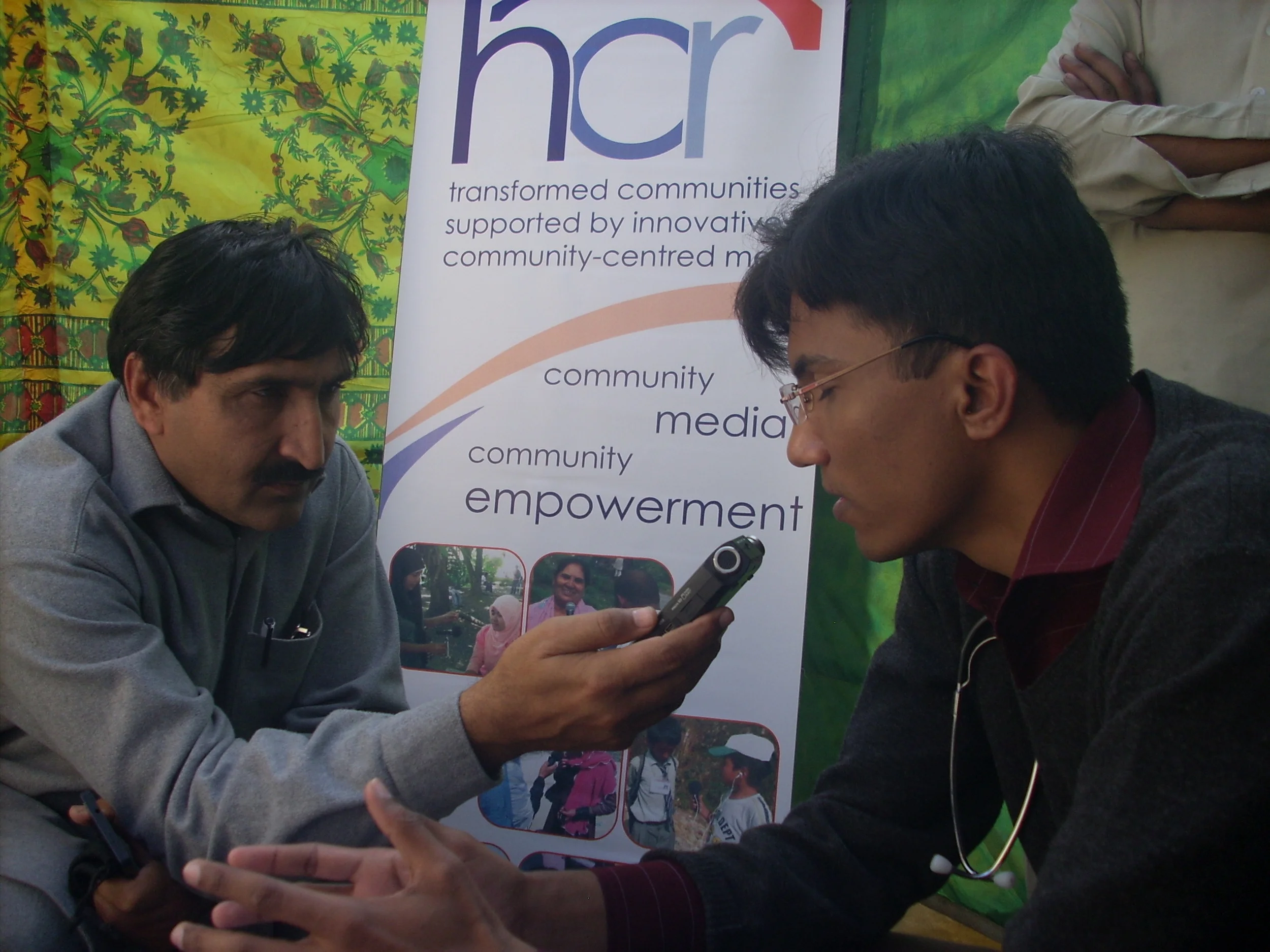 A journalist interviews one of the doctors during the camp for broadcast on local radio