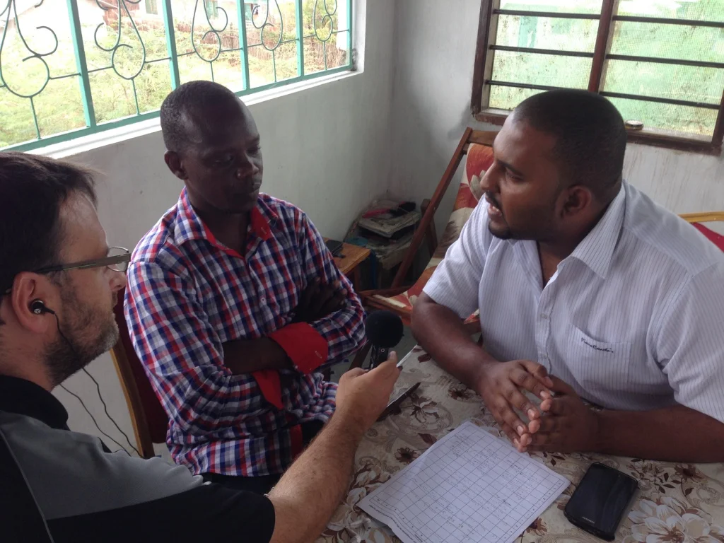 Tana FM's Shedrack Hiribae interviews Dr Badru Mohaji, Director of Special Programmes and Cohesion, about Tana River County's flood preparations, with support from HCR's Alex Stout.