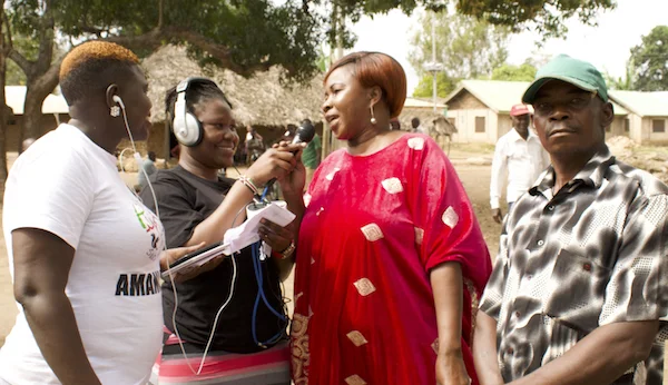 Harriet and Esther from Amani FM interview community members.