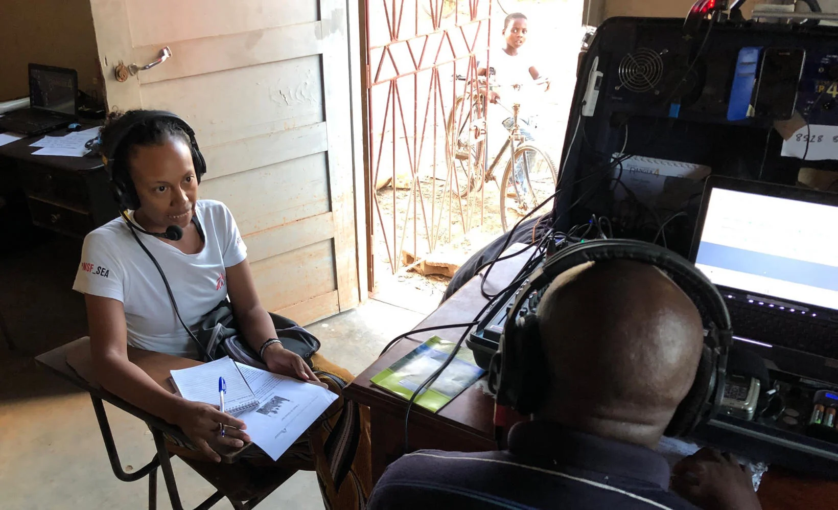 MSF psychologist gives community advice in temporary Buzi FM studio. March 2019. (Photo credit: HCR)