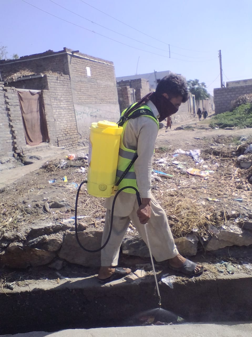 NSCSG volunteer spraying gutters in Majukay