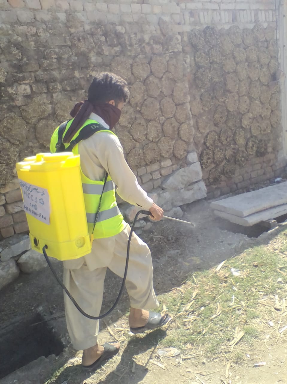 NSCSG spraying drains to prevent mosquitoes from breeding and disease from spreading