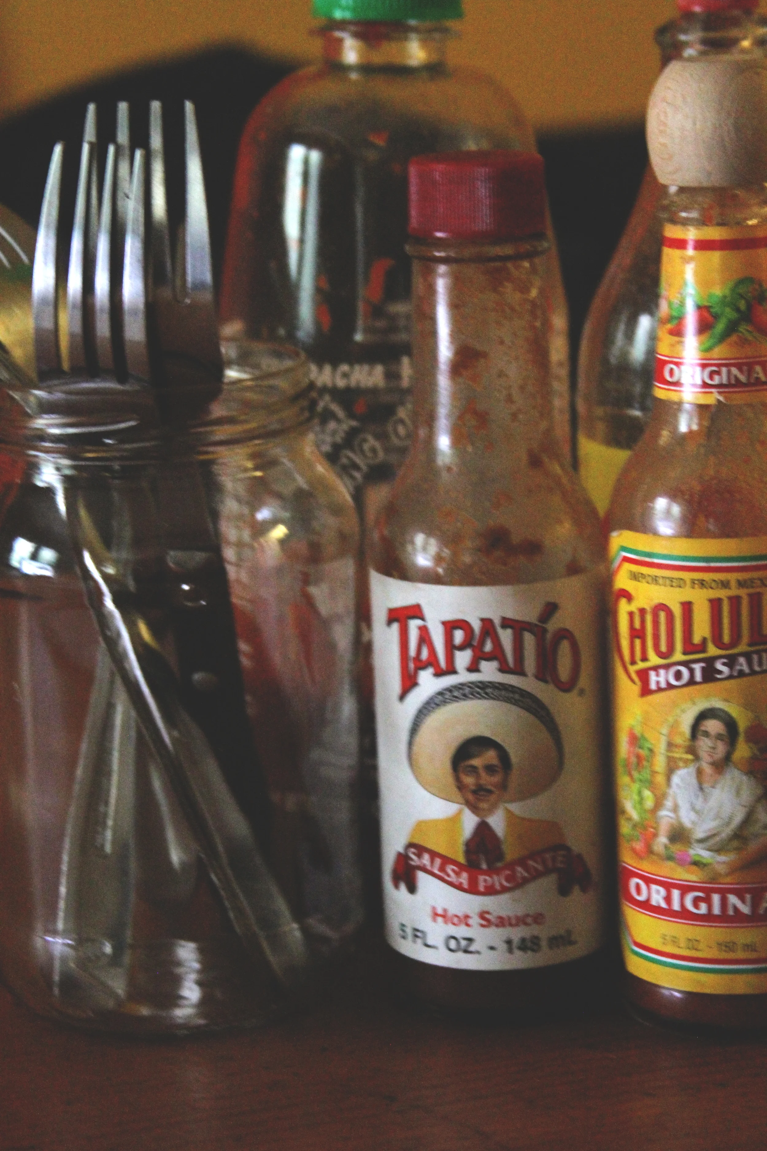 For this photo, I captured the most used items in my house: utensils and hot sauce. This says a lot about the style in which my housemates and i love to consume our food—spicy with a kick of flavor. I took a shot here at object framing and the light is casting an attached shadow on the objects. 