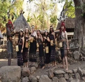 Visitors trying on tradtional clothes in Takpala, Alor, Indonesia.jpg