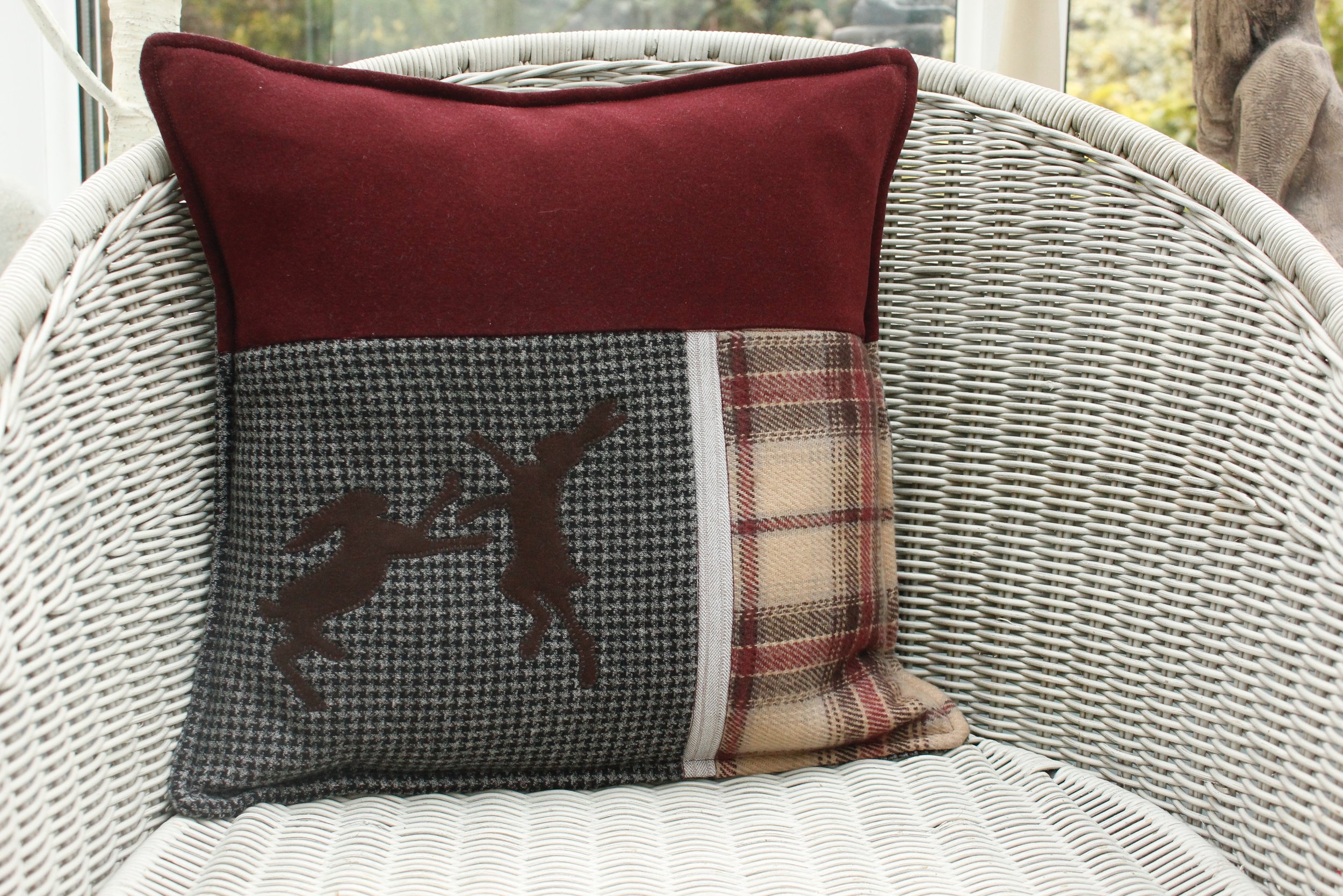Mavis's cushion made from two skirts, a suit, a pair of trousers and a scarf.
