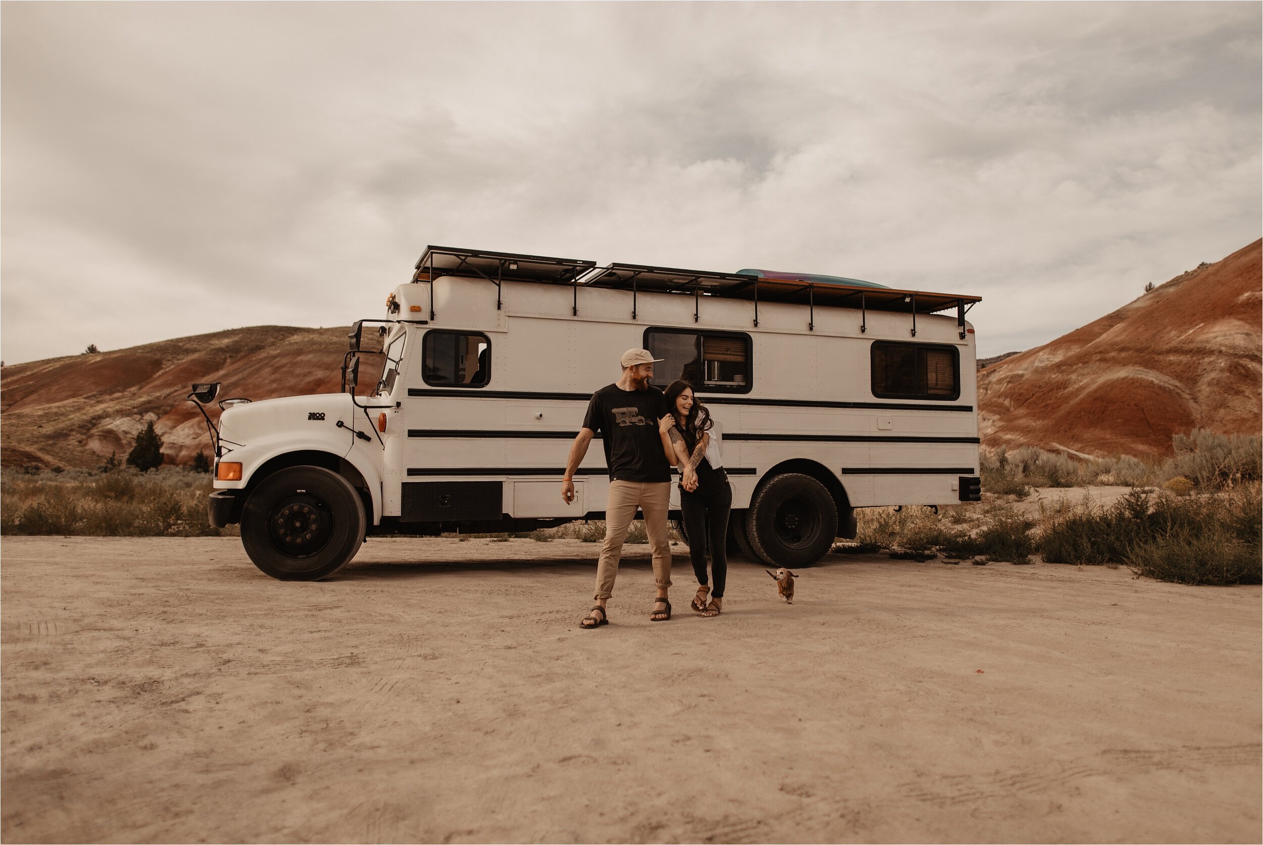 Adventure couple living in a white school bus