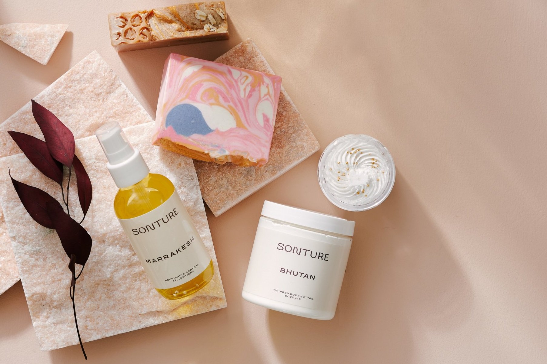 Sonture Beauty bath and body products photographed by Philadelphia photographer Tina Crespo. A flatlay of body oil, bodyy scrub and soap.