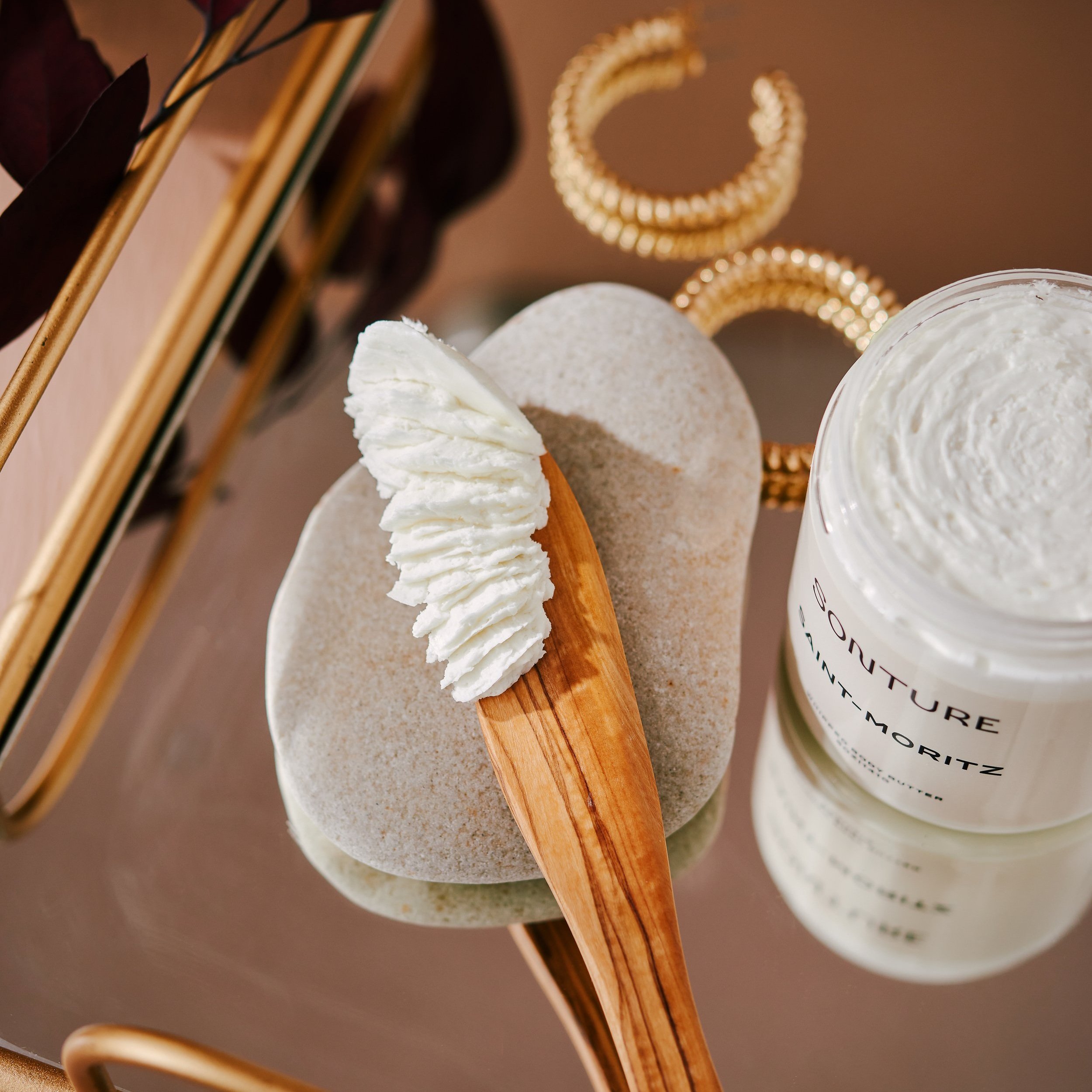 Sonture Beauty bath and body products photographed by Philadelphia photographer Tina Crespo, showcasing a wooden spoon featuring creamy body scrub.