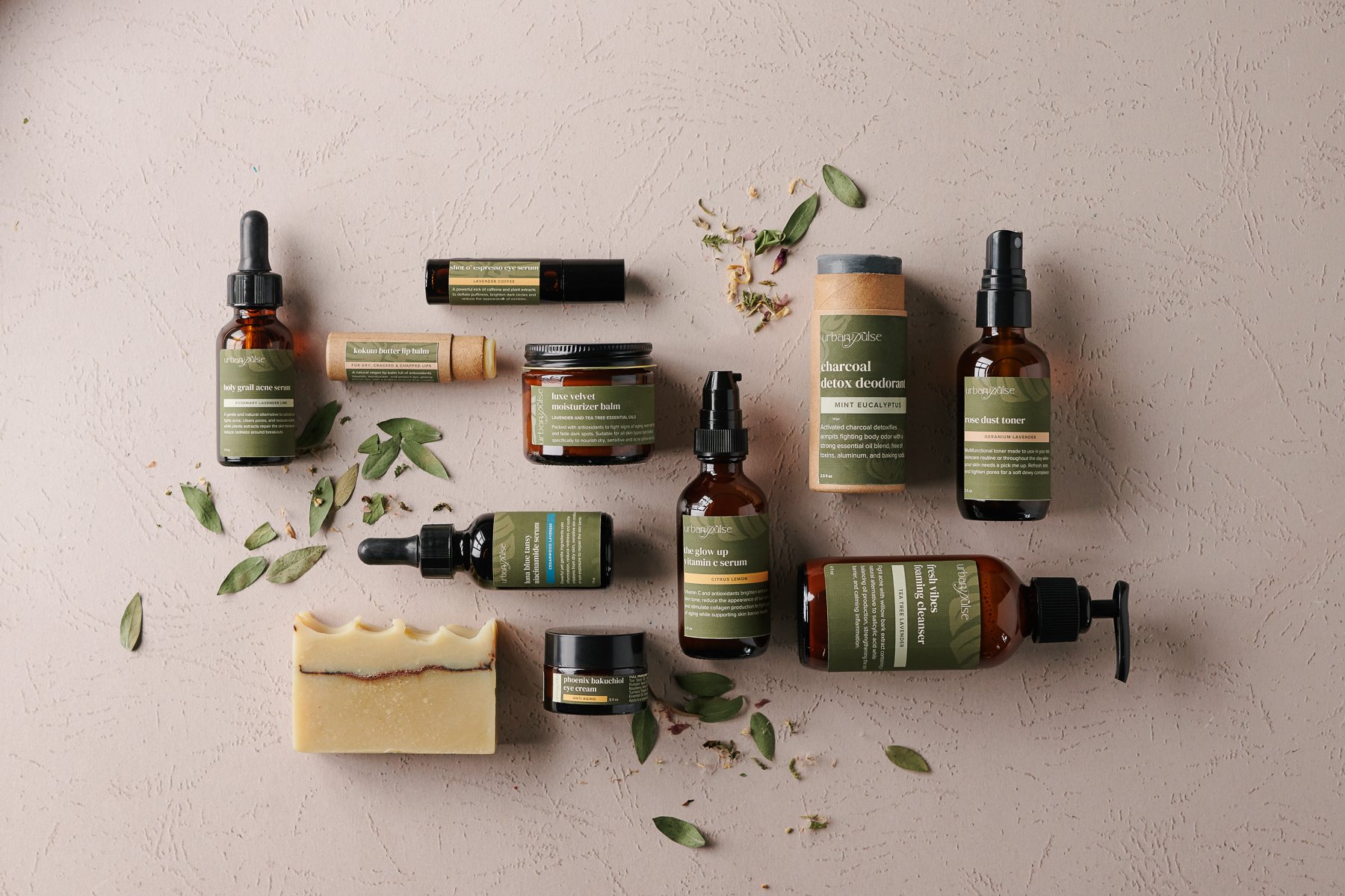 Urban Pulse bath and body products photographed by Philadelphia photographer Tina Crespo. Flatlay photograph of products on cream background.