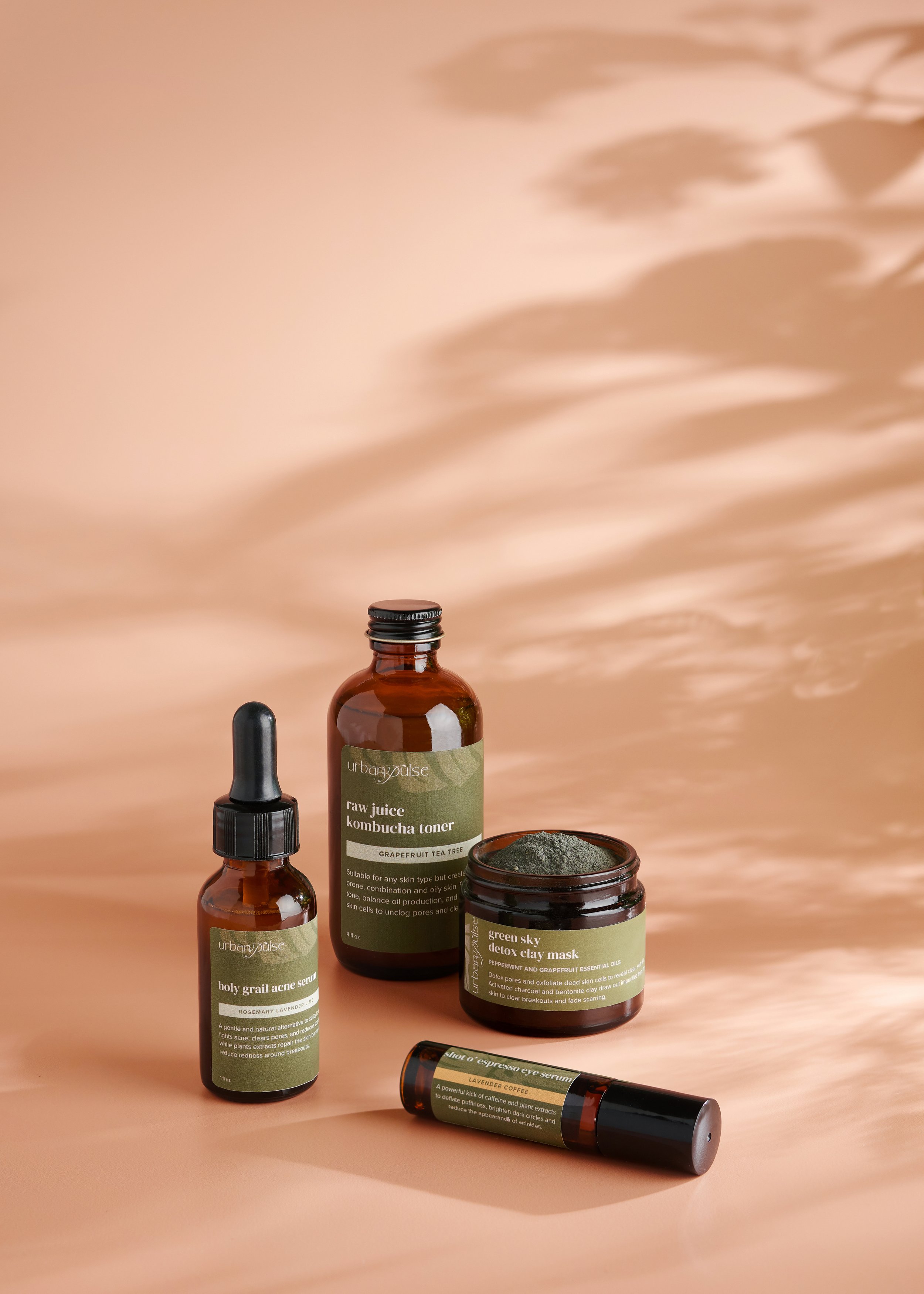 Urban Pulse bath and body products photographed by Philadelphia photographer Tina Crespo, showcasing product. line on warm tan background with shadows.