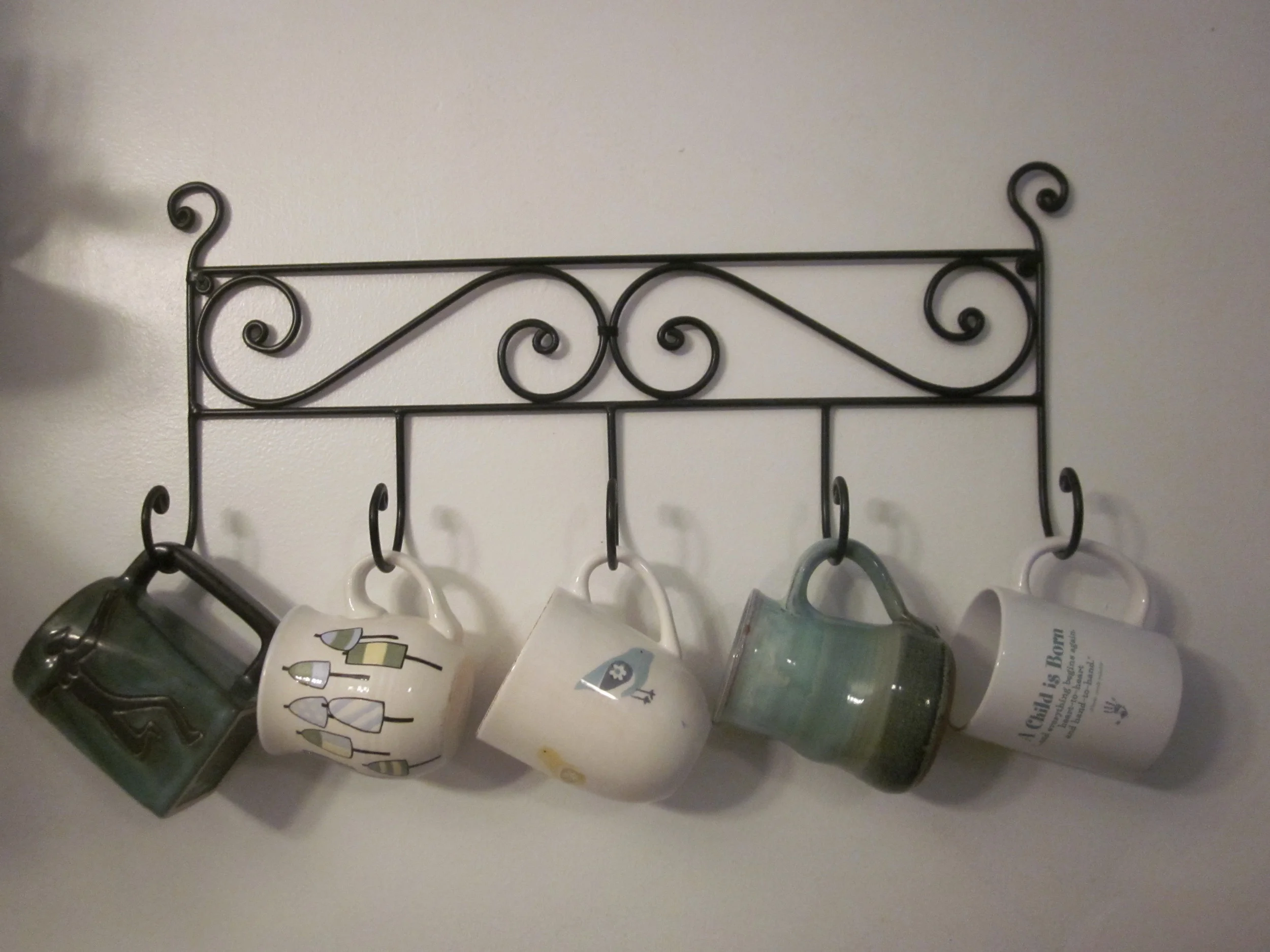 RACKING UP MEMORIES, MEANING and MESSAGES (L-R) Dancing Women -- when I need encouragement and inspiration; Beautiful Buoys -- special gift elicits memories of a Rockport, MA vacation; LITTLE BIRD -- made in Portugal, found at Pier One Imports, always makes me happy; Green/Blue Gift -- uniquely crafted tasteful ceramic treat from a special sibling; A Child is Born -- personal poetry made manifest through Cafe Press.