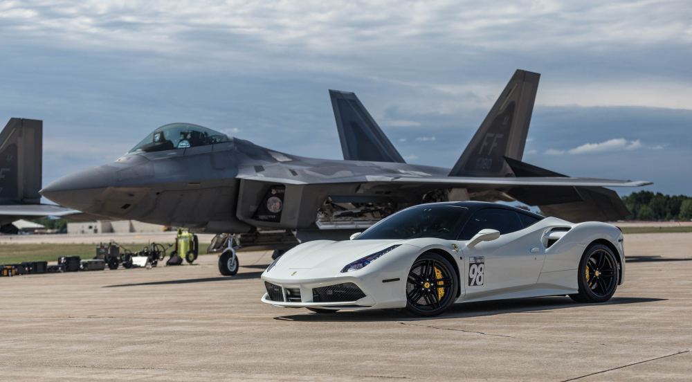Ferrari 488 posing next to a F-22 Raptor.