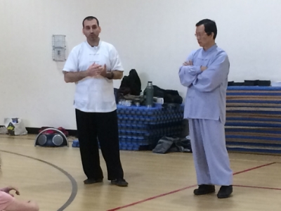 Dr. McCann translating for and assisting his Shifu Wang Fengming during a Taiji and Qigong seminar (Vermont, 2016).