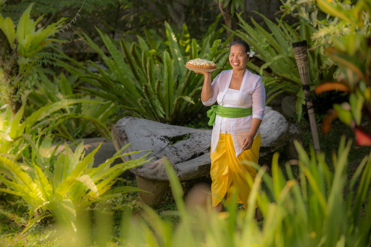 Nyoman Carries Mango Pie In Garden-Hartland-Estate.jpg