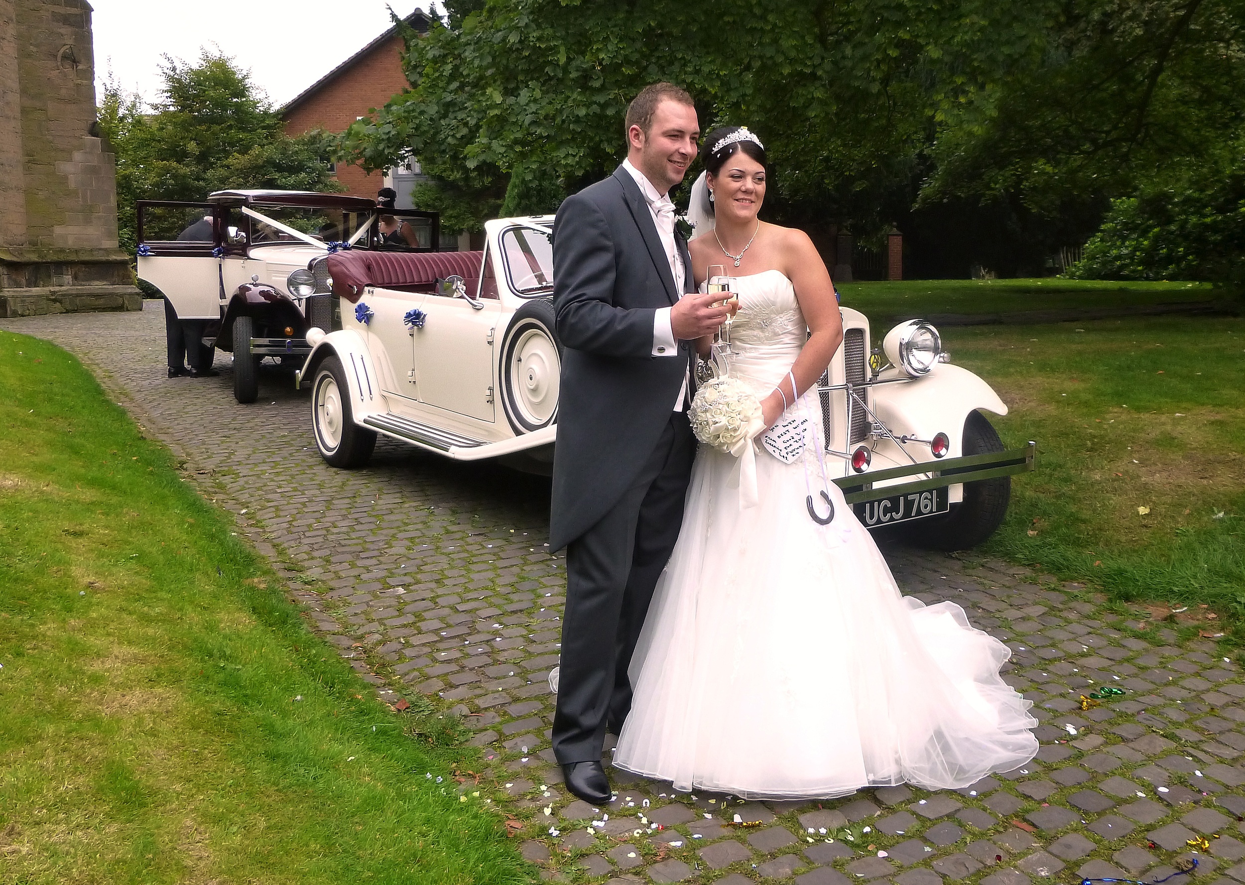Cariann and Anthony about to leave for their reception, following the celebration "toast" in the grounds of All Saints Church, Bedworth, Nuneaton, Warwickshire.