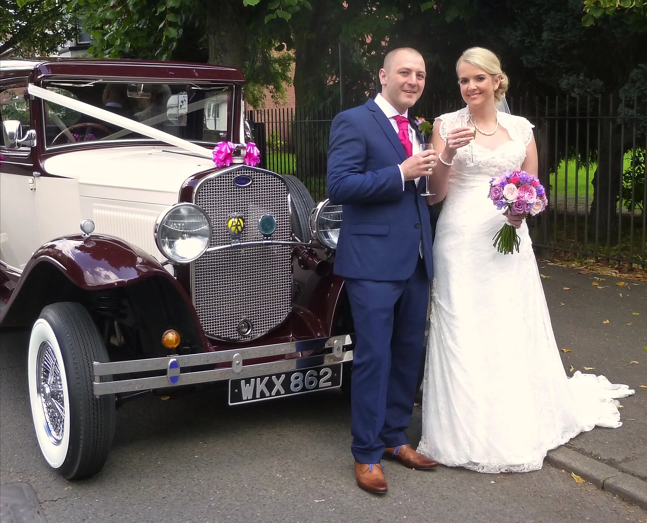 Michelle and Chris enjoying a "toast" prior to a drive around Nuneaton to their reception venue of the Ambleside Sports Club . Congratulations from Married in Style!