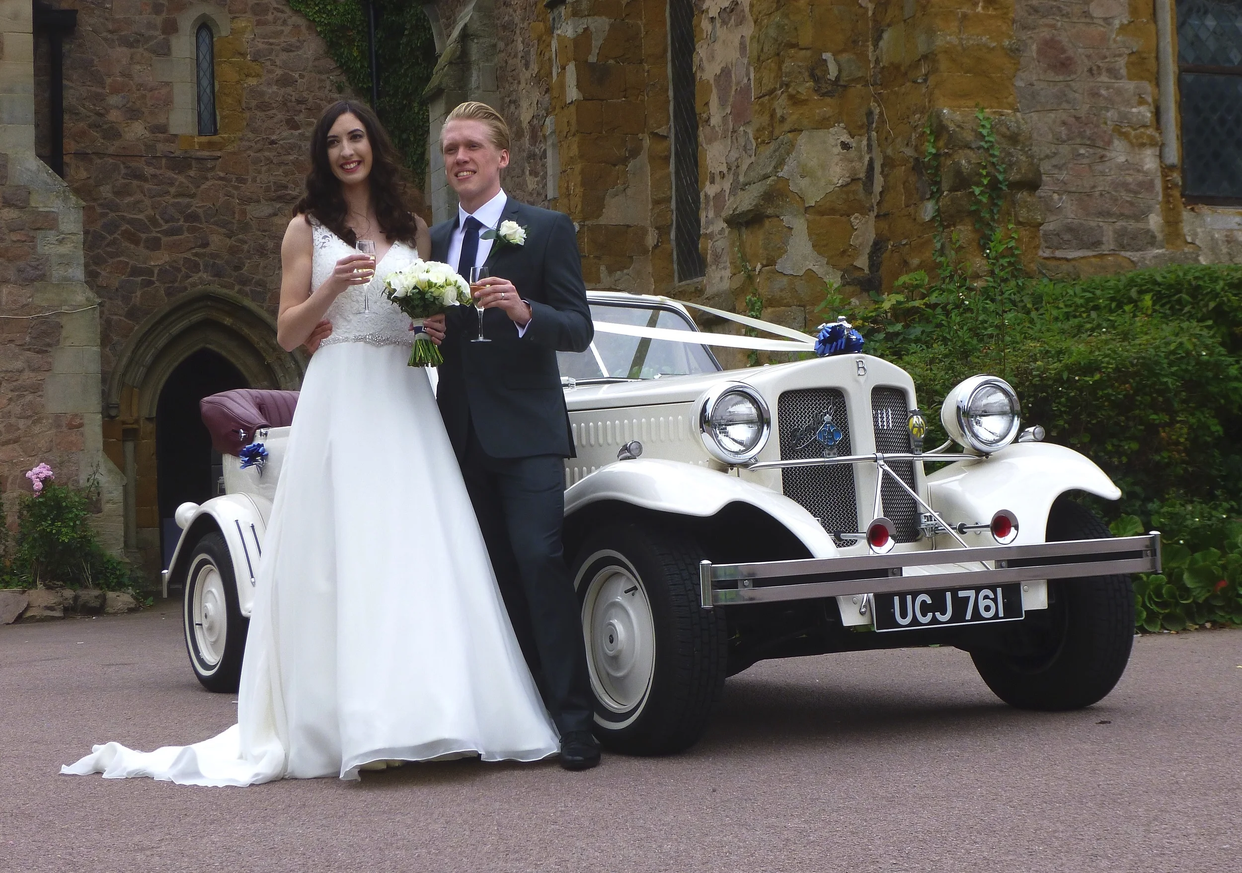 Holly and Lewis enjoying a toast prior to a drive around the village of Rothley in our Beauford Wedding Car