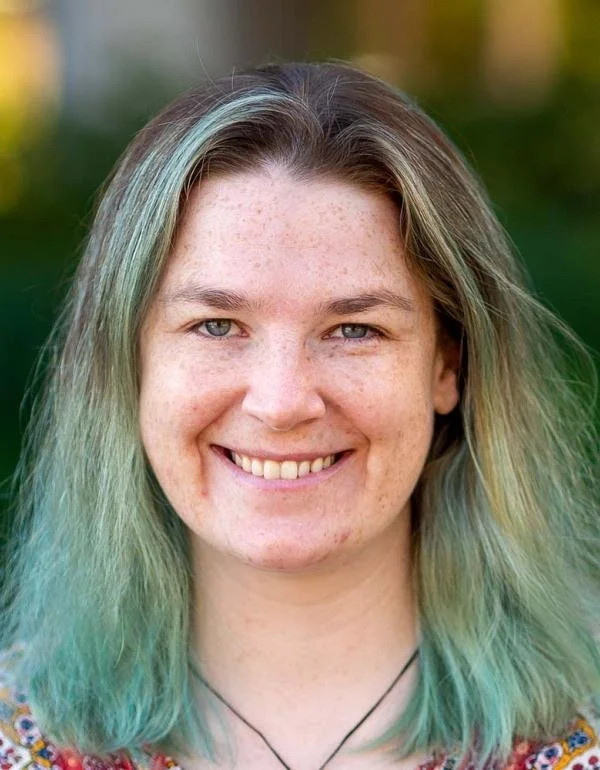 Portrait of a woman with aquamarine hair.