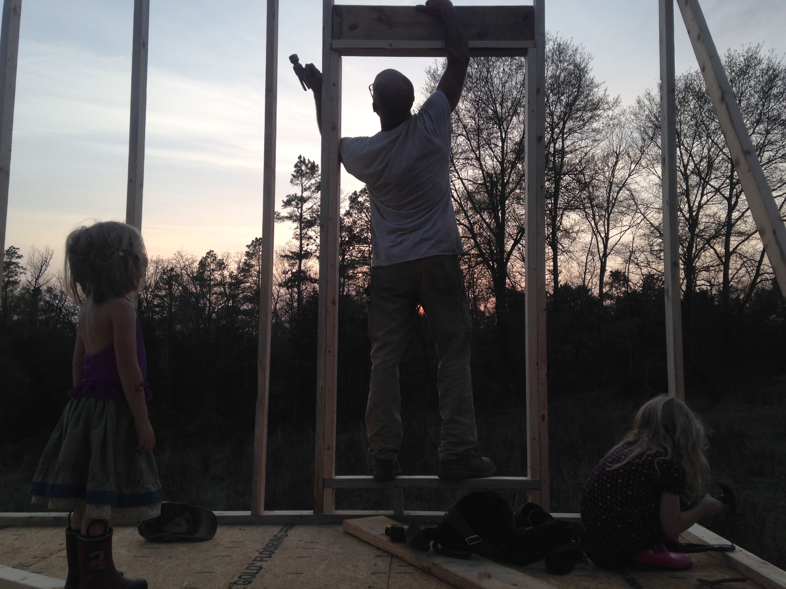 Maggie supervises a window header being installed, while Honey practices with her very own, new-to-her hammer