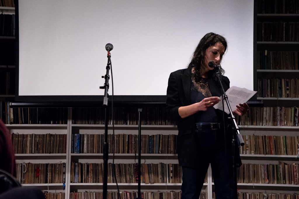 Hannah reading her essay at the Burn The Book premiere on April 19. Photo by Bridget Haggerty.