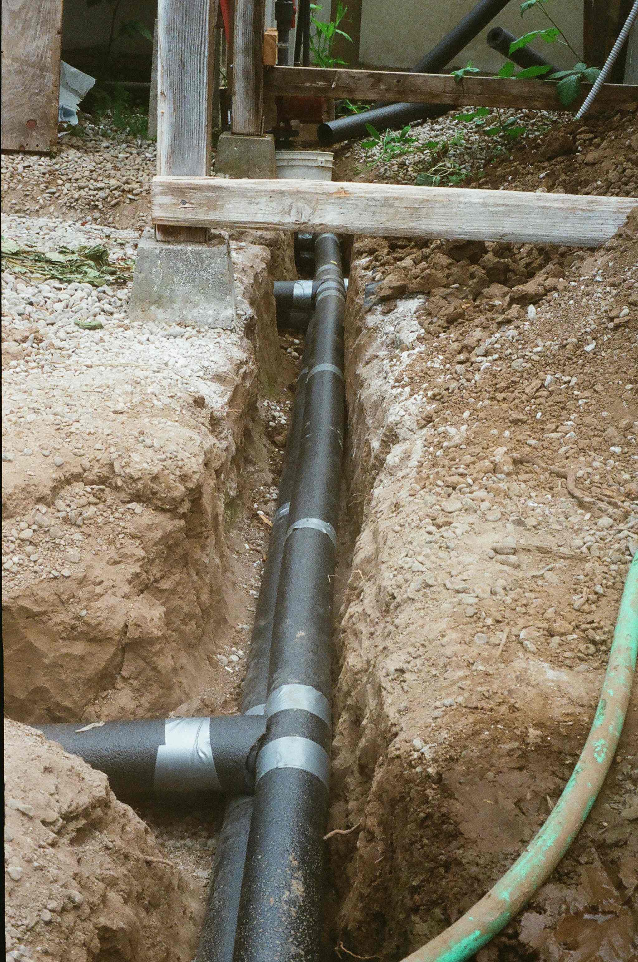  The underground pipes that deliver the hot water from the greenhouse water heater to the plant tables are insulated with foam to prevent heat loss to the ground. 