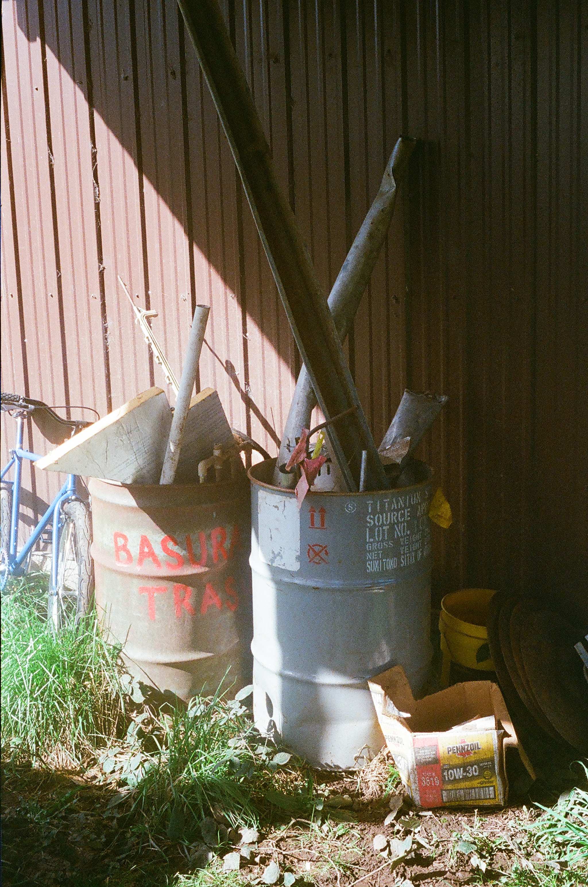 Used metals are stored in barrels and taken to a junkyard annually for recycling.