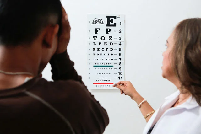 A Campos Borquez employee (left) is treated by an optometry center employee. Download high resolution image here.