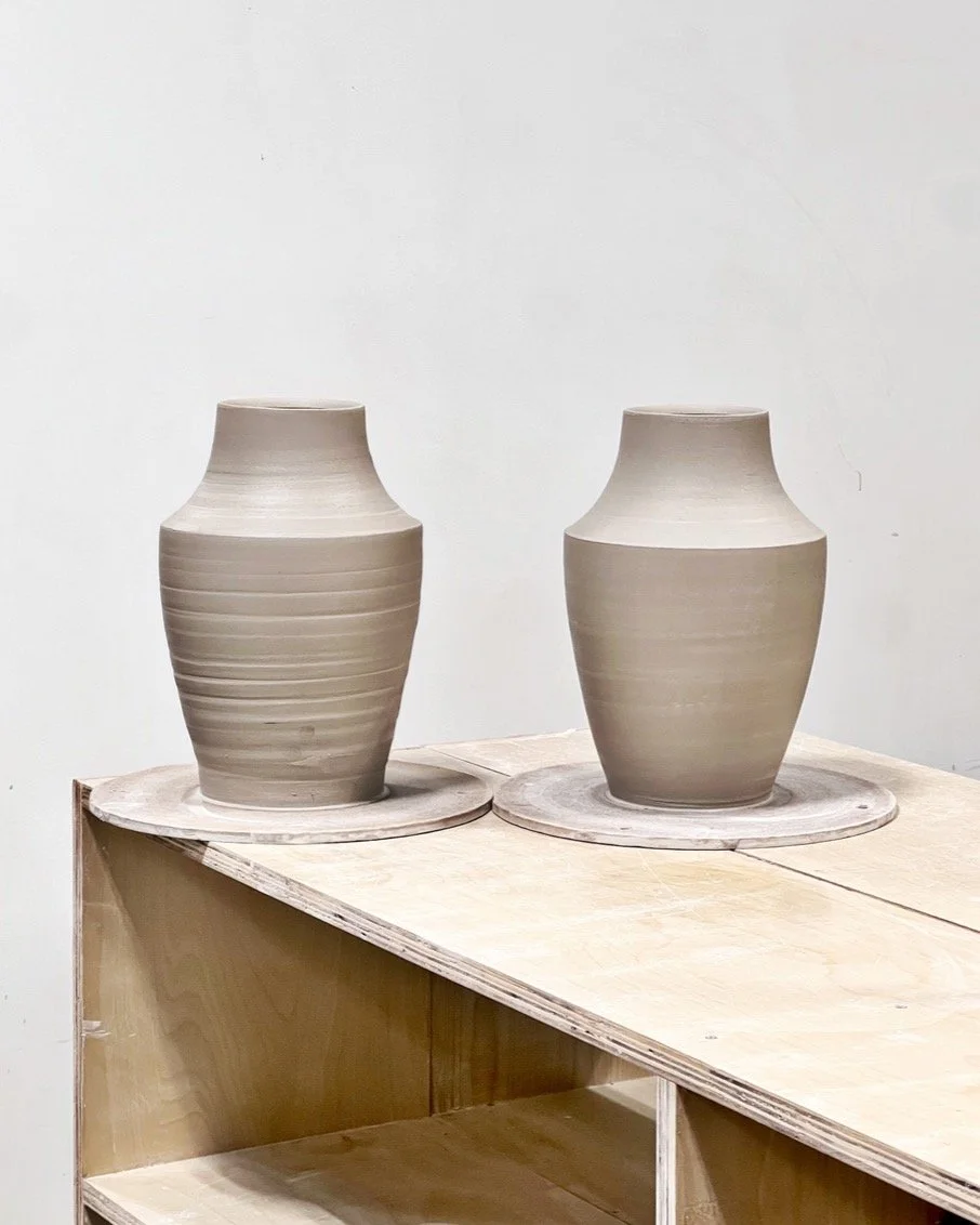 Trimming, in some instances, starts before a piece is removed from the bat. The refinement on the right is less about removing throwing rings and more about narrowing the base to improve how the shape meets the surface it's resting on. The wider base